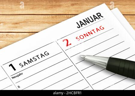 Deutscher Kalender 2022. Januar 1 Samstag und Sonntag Neujahr mit Stift auf Holzhintergrund Stockfoto