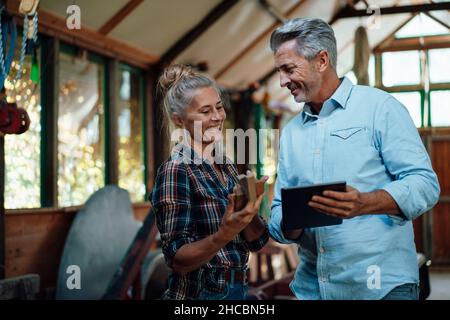 Paar schaut sich das Holzwerkzeug im Gartenschuppen an Stockfoto