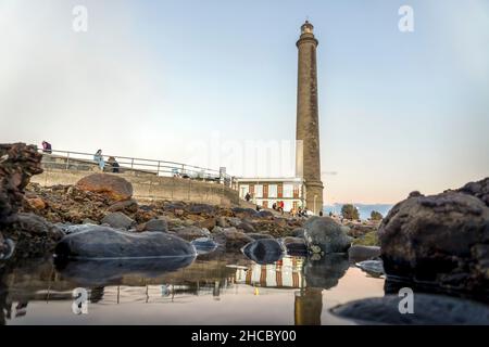 Leuchtturm an der felsigen Küste bei Sonnenuntergang in Maspalomas, Gran Canaria, Spanien Stockfoto