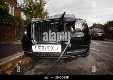 Ladestelle für Elektrofahrzeuge in der Londoner Straße mit DEM ELEKTROTAXI LEVC TX in Ladefunktion Stockfoto