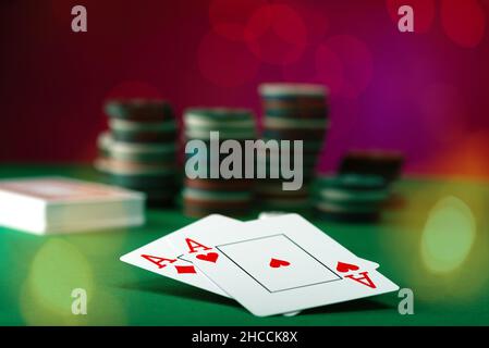 Zwei Asse und Stapel Casinochips im Hintergrund Stockfoto