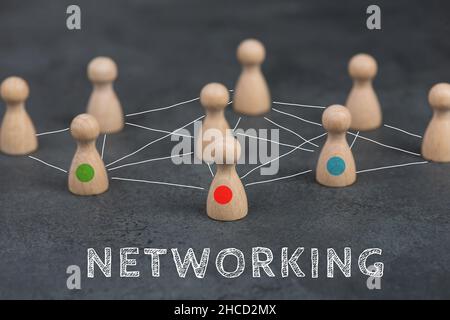 Wood figures, group of people connecting through a web, business networking and communication concept, leadership Stockfoto