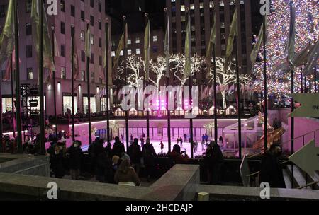 Neu, USA. 27th Dez 2021. (NEUER) Rockefeller Weihnachtsbaum und seine Attraktionen. 27. Dezember 2021, New York, USA: Der Rockefeller-Weihnachtsbaum, der am 1. Dezember 2021 offiziell der Öffentlichkeit vorgestellt wurde, zieht weiterhin New Yorker und Touristen an. Schwere Sicherheit mit Zäunen von NYPD hilft, jede Verwirrung oder Gefahr einzudämmen, während die Menschen die Gelegenheit nutzen, Fotos zu machen, zu bewundern und sogar mit der Möglichkeit, im Rockefeller Center Ski zu fahren. Die meisten Menschen verwenden Gesichtsmasken. (Bild: © Niyi Fote/TheNEWS2 via ZUMA Press Wire) Stockfoto