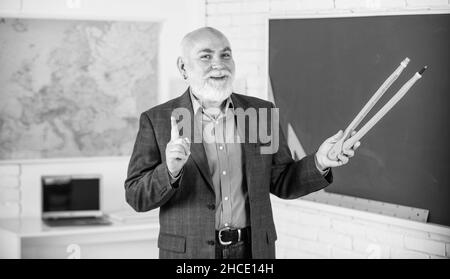 Überprüfen Sie Fehler. Bärtiger Tutor Mann zeichnen mit Kompass auf Tafel. Zurück zur Schule. Konzept für mathematische Grafikwerkzeuge. In Richtung Wissen. Studieren Sie Mathematik zu bekommen Stockfoto