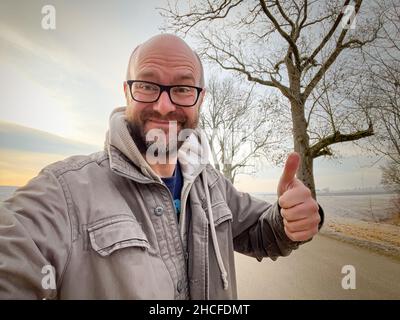 Glücklicher Mann in der bayerischen Natur im Winter Stockfoto