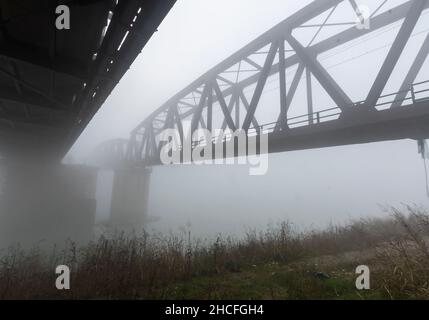 Brücke über den Po mit dichtem Nebel. Stockfoto