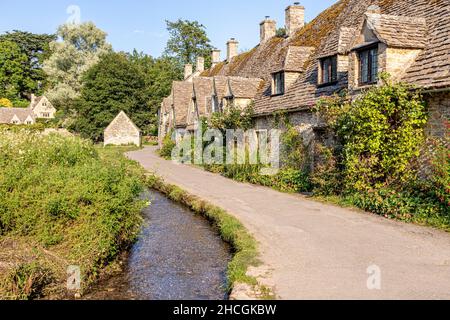 Abendlicht fällt auf die Arlington Row, Weberhütten aus dem späten 14th. Jahrhundert im Cotswold-Dorf Bibury, Gloucestershire, Großbritannien Stockfoto