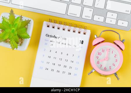 Januar 2022 Tischkalender und rosafarbener Wecker mit Keyboard-Computer. Stockfoto