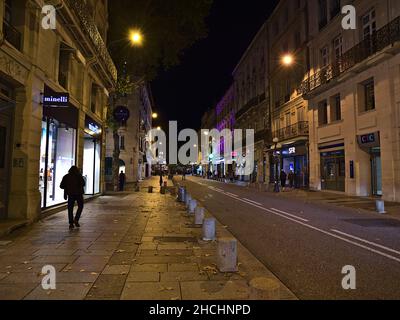 Nachtansicht der Rue de la Republique im historischen Zentrum von Avignon, Provence, Frankreich mit beleuchteten Gebäuden, Geschäften und Spaziergängen. Stockfoto