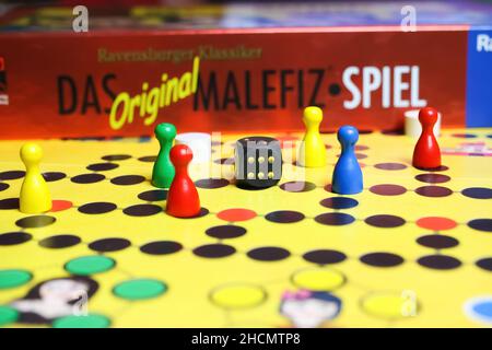 Viersen, Deutschland - Mai 9. 2021: Blick auf gelbes Spielbrett mit bunten Figuren und Würfeln des alten ravensburger Strategiespiel malefiz Stockfoto