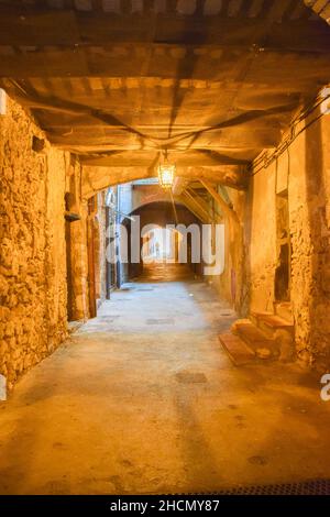 Rue obskure mittelalterliche überdachte Straße. Villefranche Sur Mer, Südfrankreich, August 2019. Stockfoto