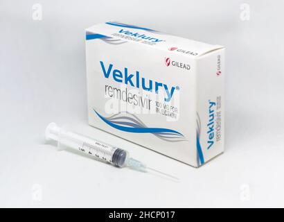 Foster City, CA, USA, Dezember 2021: Eine Spritze neben der Gilead Veklury Remdesivir Covid-19 Behandlungsbox, isoliert auf weißem Hintergrund. Gesundheit und Stockfoto