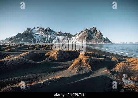 Luftdrohnenansicht eines herrlichen sonnigen Tages und einer wunderschönen Reflexion des Vestrahorn Bergs auf dem Stokksnes Kap in Island. Lage: Stokksnes Kap Stockfoto