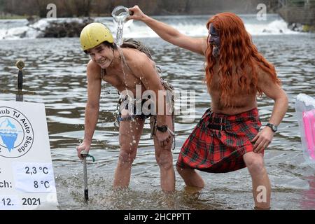 Mlada Boleslav, Tschechische Republik. 31st Dez 2021. Menschen, die während der Taufe in Mlada Boleslav in der Nähe der Fabrik Skoda Auto in der Tschechischen Republik im eiskalten Wasser des Flusses Jizera schwimmen. Begeisterte Schwimmer trotzen jedes Jahr dem kalten Wasser zum Schwimmen und Taufe neue Schwimmer. (Bild: © Slavek Ruta/ZUMA Press Wire) Stockfoto