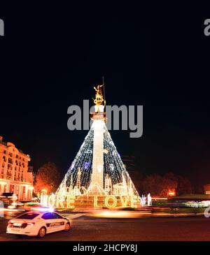 Tiflis, Georgien - 12th. dezember, 2021: Polizei Patrouille Fahrzeug stehen in der Straße am Kreisverkehr und vorbei Autos am Kreisverkehr passieren in Freiheit Platz auf C Stockfoto