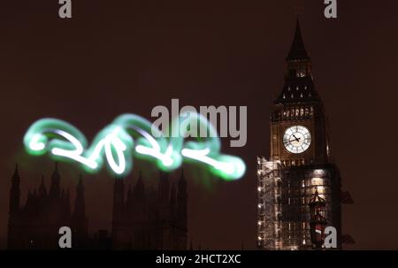 London, Großbritannien. 31st Dez 2021. Das am 31. Dezember 2021 aufgenommene Foto zeigt den Big Ben mit dem Lichtbild '2022' in London, Großbritannien. Kredit: Li Ying/Xinhua/Alamy Live Nachrichten Stockfoto