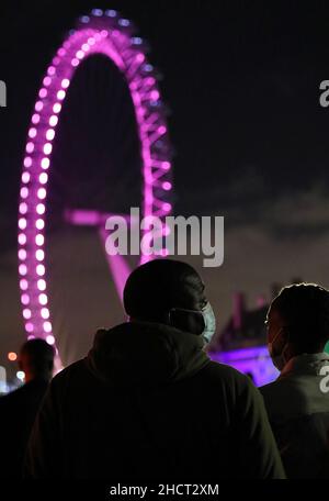 London, Großbritannien. 31st Dez 2021. Maskierte Menschen begrüßen das neue Jahr in der Nähe des London Eye in London, Großbritannien, 31. Dezember 2021. Kredit: Li Ying/Xinhua/Alamy Live Nachrichten Stockfoto