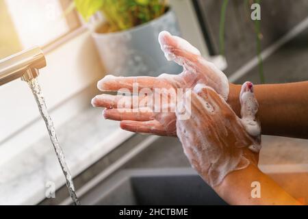 Hygiene. Hände Reinigen. Händewaschen mit Seife in der Küche Stockfoto