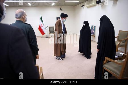 Teheran, Iran. 1st Januar 2022. Ein Handout-Bild, das vom Obersten Imam des Iran zur Verfügung gestellt wurde, zeigt, dass der iranische Oberste Imam ALI KHAMENEI (C) die Witwe und andere Familienmitglieder des ermordeten iranischen Revolutionsgarden-Korps (IRGC), Generalleutnant und Kommandeur der Quds-Truppen, Qasem Soleimani, vor dem zweiten Todestag begrüßt, In Teheran, Iran, 01. Januar 2022. Der Iran wird am 03. Januar 2022 den zweiten Todestag von Soleimani begehen. Der oberste iranische General wurde bei einem gezielten US-Luftangriff am 03. Januar 2020 in Bagdad, Irak, getötet. (Bild: © IR Bild: Z Stockfoto