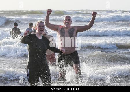 Irvine, Großbritannien. 1st Januar 2022. Mehr als 150 Schwimmer nahmen am Annual Loony Dook Swim vor dem Strand von Irvine bei Meerestemperaturen von weniger als 9C Teil. Viele der Schwimmer, die daran teilnahmen, sammeln Gelder für lokale und nationale Wohltätigkeitsorganisationen Kredit: Findlay/Alamy Live News Stockfoto