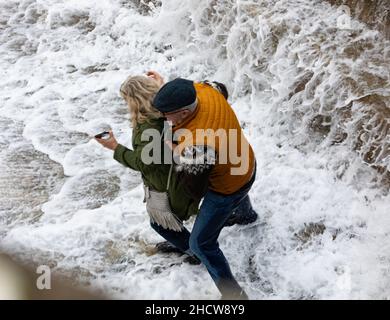 Portreath,Cornwall,1st. Januar 2022,große Wellen und stürmische Meere in Portreath,Cornwall, verursacht durch starke Südwestwinde heute Morgen. Zwei Menschen wurden von den Wellen gefangen, als sie über die Hafenmauer kamen, sodass sie wegliefen und dabei durchnässt wurden.die Temperatur lag bei 13C, was für die Jahreszeit mild ist. Die Prognose ist, dass es sich um stürmische Winde für heute handelt, die sich heute Abend beruhigen werden.Quelle: Keith Larby/Alamy Live News Stockfoto