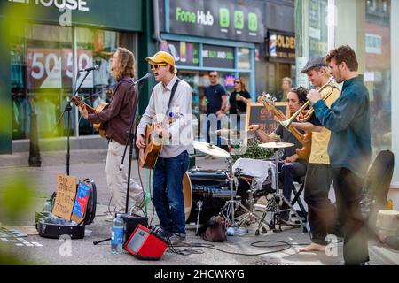 Straßenmusiker treten an einem geschäftigen samstagmorgen in Stroud, Gloucestershire, Großbritannien, auf Stockfoto