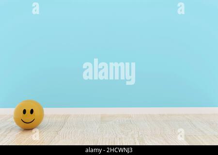 Gelber Smiley-Ball im blauen Rauminneren in 3D-Rendering Stockfoto