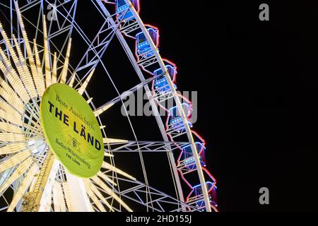 Stuttgart, 31. Dezember 2021: Riesenrad mit beleuchteten Gondeln isoliert auf schwarzem Hintergrund. Teil einer Attraktion. Die beste Aussicht (The lä Stockfoto