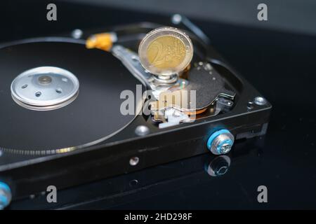 Eine Euro-Münze steht auf einer offenen Festplatte Stockfoto