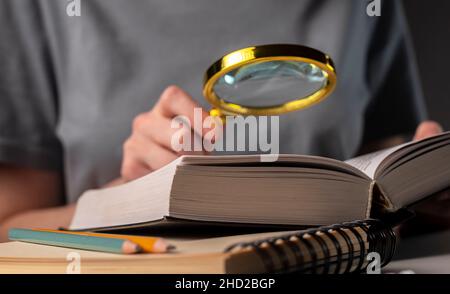 Weibliche Studenten Hände halten Bleistift und Buch lesen, bereiten Sie sich auf die Prüfung am Tisch in der Nacht. Bildungskonzept. Stockfoto