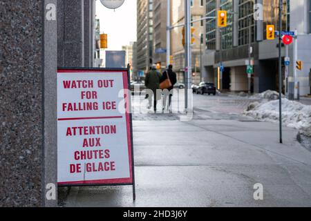 Ottawa, Kanada - 16. Dezember 2021: Schild auf dem Bürgersteig warnt die Menschen vor der Gefahr, dass Eis und Schnee aus dem Gebäude fallen. Text in Engli Stockfoto