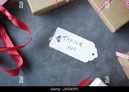 Danksagung und Geschenkbox auf schwarzem Hintergrund Stockfoto