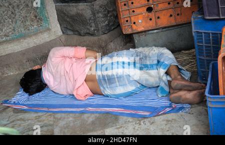 Ein Mann, der auf dem Boden in Crawford Market, Mumbai, Indien, Stockfoto