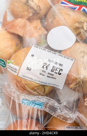 BRAUNE Zwiebeln/Allium cepa in Kunststoffpackungen. Auch als gelbe Zwiebeln + Best Before Date Label / BBD bezeichnet. Für gemeinsame Küchenzutaten & medizinische. Stockfoto