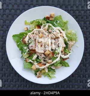 Caesar-Salat mit gegrilltem Hähnchensalat, Mayonnaise-Croutons und geriebenem Käse. Stockfoto