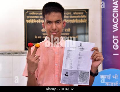 BIKANER, Rajasthan, Indien. 3rd Januar 2022. Ein kleiner Junge, der einem Teenager in Bikaner den COVID-19-Impfstoff-Satifiket zeigt. Die Impfung von Jugendlichen im Alter zwischen 15 und 18 Jahren in Indien begann am Montag. (Bild: © Dinesh Gupta/Pacific Press via ZUMA Press Wire) Stockfoto