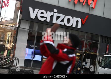 New York, USA. 03rd Januar 2022. Blick auf einen Mann, der ein Foto mit dem Verizon Wireless-Einzelhandelsgeschäft hinter sich macht, New York, NY, 3. Januar 2022. Die Mobilfunkdienste AT&T Inc. Und Verizon haben beschlossen, dem Antrag der Federal Aviation Administration und des Transportministeriums, den neuen Dienst 5G zu verschieben, nicht zu folgen, da er die Elektronik von Flugzeugen beeinträchtigen könnte; Während die Fluggesellschaften sagten, sie könnten eine Pause auf den 5G in der Nähe von Flughäfen anbieten, prognostiziert die Fluggesellschaft Flugstörungen und Verspätungen, wenn sie dies nicht tun. (Foto von Anthony Behar/Sipa USA) Quelle: SIPA USA/Alamy Live News Stockfoto