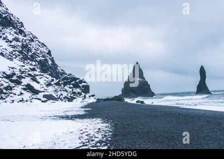 Die Wellen schlagen sich über die Reynisdrangfer Seastacks vor dem Reynisfjara Beach Stockfoto