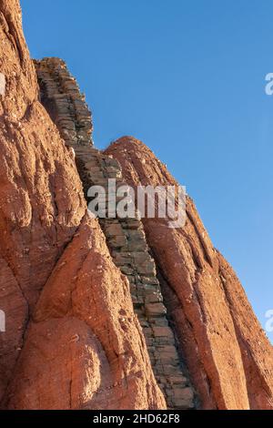 Kolumnar basaltische Felsenintrusion in rotem Sandsteinkonglomerat, Rode O, Rodefjord, Scoresby Sund, Grönland Stockfoto