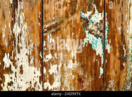 Der Hintergrund ist aus Holz geknüpft aus alten Brettern mit abblätternder Farbe weiß türkis gelöscht. Stockfoto