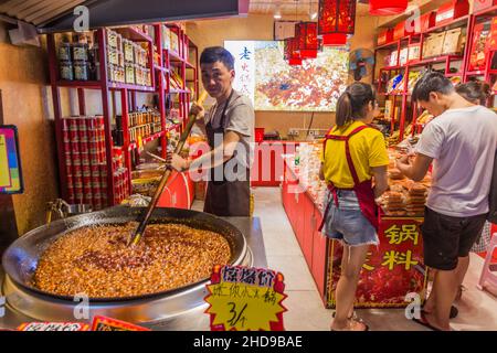 CHONGQING, CHINA - 17. AUGUST 2018: Süßwarenhersteller in der antiken Stadt Ciqikou, China Stockfoto