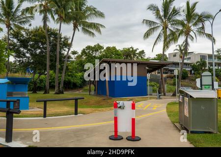 Airlie Beach, Queensland, Australien - Januar 2022: Fußweg vorbei an Mülltonnen, Grillmöglichkeiten und Toilettenanlagen für öffentliche Spaziergänge am Strand Stockfoto