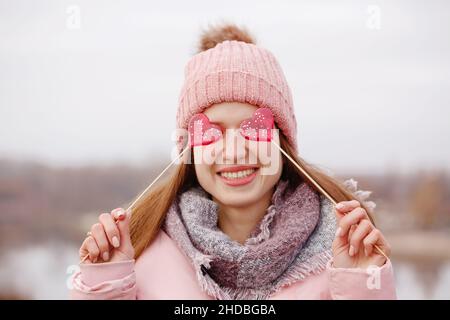 Schöne Mädchen hält einen Lutscher. Das Konzept für den Valentinstag Stockfoto