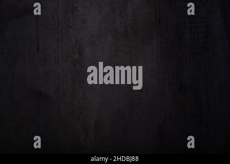 Dunkelgrauer Hintergrund mit Holzstruktur. Stockfoto