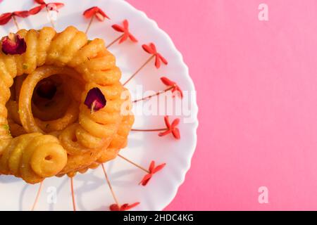 Beliebte indische pakistanische süße Gericht Imarti. Auch bekannt als Amriti oder Omriti ähnlich wie Jalebi mit kreisförmigen Blütenform Design tiefes Braten in Clarifie Stockfoto