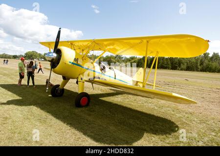 Einmotorige alte gelbe Doppelflügel-Doppeldecker bei der Sammlung von Flugzeugen auf dem städtischen Flughafen angezeigt. Schlacht am Lake Minnesota, USA Stockfoto