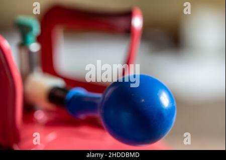 Selektiver Fokus auf den Rand eines aufblasbaren Ballons, der an einem Heliumbehälter befestigt ist. Stockfoto