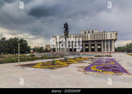 BISCHKEK, KIRGISISTAN - 11. JULI 2018: Philarmonische Halle mit dem Namen Toktogul Satylganov und Manas Statue in Bischkek, der Hauptstadt Kirgisistans. Stockfoto