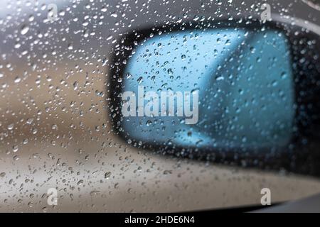 Blick auf die Autoglasscheibe bei Regen mit Regentropfen Stockfoto