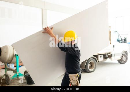 Tragen, Bauarbeiter, Gipskarton, tragen, blauer Kragen, baumeister, Bauarbeiter, Arbeiter, Gipskartonplatten Stockfoto
